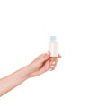 Female hand holding cream bottle of lotion isolated. Girl give tube cosmetic products on white background Royalty Free Stock Photo