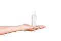 Female hand holding cream bottle of lotion isolated. Girl give tube cosmetic products on white background Royalty Free Stock Photo