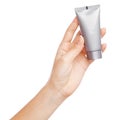 Female hand holding a cream tube