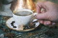 Female hand holding a cup of hot steaming coffee Royalty Free Stock Photo