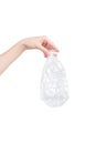 Female hand holding empty crushed plastic bottle isolated on white. Recyclable waste. Recycling, reuse, garbage disposal Royalty Free Stock Photo