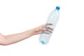 Female hand holding empty plastic bottle isolated on white. Recyclable waste. Recycling, reuse, garbage disposal, resources, envir Royalty Free Stock Photo