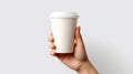 Female hand holding empty white blank paper cup of coffee with a cap. Isolated on white background with copy space Royalty Free Stock Photo