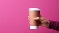 Female hand holding empty white blank paper cup of coffee with a cap. Isolated on magenta background with copy space Royalty Free Stock Photo