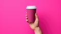 Female hand holding empty white blank paper cup of coffee with a cap. Isolated on magenta background with copy space Royalty Free Stock Photo