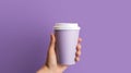 Female hand holding empty white blank paper cup of coffee with a cap. Isolated on violet background with copy space Royalty Free Stock Photo