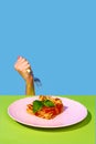 Female hand holding fork over delicious Italian food, lasagna over green and blue background Royalty Free Stock Photo