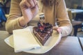 Piece of cake on a plate in woman hands