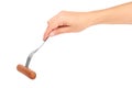 Female hand holding fork with sausage. Isolated on white background Royalty Free Stock Photo