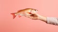 Female hand holding fresh red tilapia fish isolated on pink background Generative AI Royalty Free Stock Photo