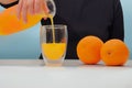 Female hand holding glass jar of fresh squeezed orange juice Royalty Free Stock Photo