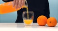 Female hand holding glass jar of fresh squeezed orange juice Royalty Free Stock Photo