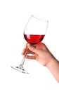 Female hand holding glass with tasty wine on white background Royalty Free Stock Photo