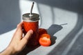 Female hand holding glass of tomato juice. Royalty Free Stock Photo