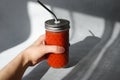 Female hand holding glass of tomato smoothie. Royalty Free Stock Photo