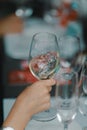 Female hand holding a glass of white wine during wine tasting Royalty Free Stock Photo