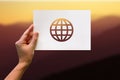 Female hand holding globe perforated paper craft in mountain background Royalty Free Stock Photo