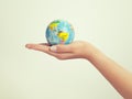Female hand holding globe. save the earth and success concept Royalty Free Stock Photo