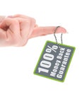 Female hand holding guarantee tag over white