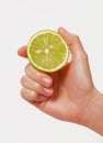 Female hand holding half fresh lime. Royalty Free Stock Photo