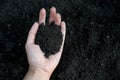 Female hand holding a handful of rich fertile soil that has been newly dug over or tilled in a concept of conservation Royalty Free Stock Photo