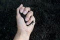 Female hand holding a handful of rich fertile soil that has been newly dug over or tilled in a concept of conservation