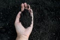 Female hand holding a handful of rich fertile soil that has been newly dug over or tilled in a concept of conservation Royalty Free Stock Photo
