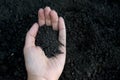 Female hand holding a handful of rich fertile soil that has been newly dug over or tilled in a concept of conservation of nature a Royalty Free Stock Photo