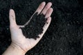 Female hand holding a handful of rich fertile soil that has been newly dug over or tilled in a concept of conservation Royalty Free Stock Photo