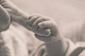 Female hand holding her newborn baby hand. Mom with her child. Maternity, family, birth concept Royalty Free Stock Photo