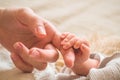 Female hand holding her newborn baby hand. Mom with her child. Maternity, family, birth concept Royalty Free Stock Photo