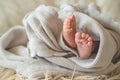 Female hand holding her newborn baby legs. Mom with her child. Maternity, family, birth concept Royalty Free Stock Photo