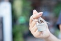 Female hand holding house key on home shaped key chain. Royalty Free Stock Photo