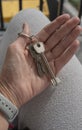 Female Hand Holding House Keys .agent handing over house keys in hand. Close-up view of keys from new home Royalty Free Stock Photo