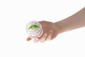 Female hand holding a jar of cream on a white background, the concept of face and body skin care, moisturizing, anti-wrinkle, coll Royalty Free Stock Photo