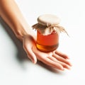 Female hand holding a jar of sweet honey. Healthy foods. AI generated Royalty Free Stock Photo