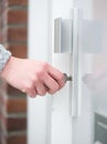 Female hand holding key inserting in door lock