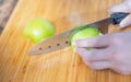 Female hand holding knife and  preparing cut off the fresh green apple for made the juice, The fresh fruit  food concept Royalty Free Stock Photo