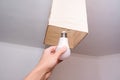 Female hand holding a led light bulb to change, replace it at home, screwing in the bulb into a lamp holder for energy saving and Royalty Free Stock Photo