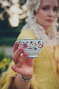 Female hand holding luxurious medieval coffee cup, close up, selective focus Royalty Free Stock Photo