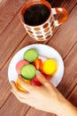 Female hand holding macarons cookie. Royalty Free Stock Photo