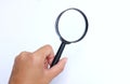 Female hand holding  Magnifying glass  isolate on a white background Royalty Free Stock Photo