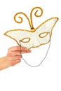 Female hand holding masquerade mask