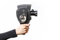 Female hand holding old style 8 mm movie camera on a white background Royalty Free Stock Photo