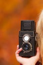 Female hand holding old vintage camera outdoor