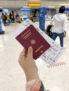 female hand holding passport citizen Russia, air tickets, documents in airport waiting room, check-in passengers for flight,