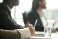 Female hand holding pen making notes at meeting, closeup view Royalty Free Stock Photo