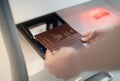 Female hand holding personal passport scaning at the self service checkin counter for get boarding pass at the airport terminal