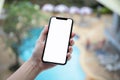 Female hand holding phone with isolated screen background pool h Royalty Free Stock Photo