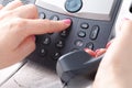 Female hand holding phone receiver and dialing number Royalty Free Stock Photo